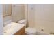 Bathroom featuring a toilet, shower, sink, towel rack, and wood-framed mirror at 7506 W Devonshire Ave, Phoenix, AZ 85033