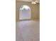 Bright bedroom featuring neutral tile floors, a ceiling fan and a unique arched window at 7506 W Devonshire Ave, Phoenix, AZ 85033