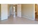 Spacious bedroom featuring tile flooring, neutral walls, and several doors leading to other rooms at 7506 W Devonshire Ave, Phoenix, AZ 85033