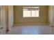 Bedroom featuring tile flooring, neutral walls, a window, and a closet at 7506 W Devonshire Ave, Phoenix, AZ 85033