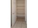 Open closet with tiled floor and multiple shelves for optimal storage capacity at 7506 W Devonshire Ave, Phoenix, AZ 85033