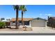 Charming single-story home with a two-car garage and palm trees in the front yard, under a clear blue sky at 7506 W Devonshire Ave, Phoenix, AZ 85033