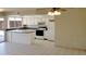 Bright kitchen with white cabinets, black appliances, tile flooring, and plenty of counter space at 7506 W Devonshire Ave, Phoenix, AZ 85033