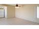 Living room featuring neutral walls and tile flooring, with ceiling fan and window at 7506 W Devonshire Ave, Phoenix, AZ 85033