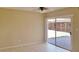 Bright, open living room featuring neutral walls and large sliding doors leading to the backyard at 7506 W Devonshire Ave, Phoenix, AZ 85033
