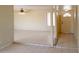 Bright living room with tile flooring, ceiling fan, and front entry door at 7506 W Devonshire Ave, Phoenix, AZ 85033