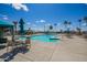A community pool with covered seating and palm trees with desert landscaping around the pool at 7807 E Main St # Cc105, Mesa, AZ 85207