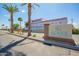 Exterior shot of 'Agave Village' sign with palm trees and desert landscaping on a sunny day at 7807 E Main St # Cc105, Mesa, AZ 85207