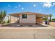 Well-maintained mobile home featuring a covered porch and carport area with low maintenance landscaping at 7807 E Main St # Cc105, Mesa, AZ 85207