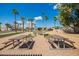 Outdoor picnic tables and fire pit area with desert landscaping at 7807 E Main St # Cc105, Mesa, AZ 85207