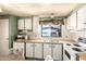 Classic kitchen features a bright interior with white appliances, wood-style countertops, and ample cabinet space at 7807 E Main St # Cc105, Mesa, AZ 85207