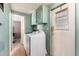 Bright laundry room with a washer and dryer, cabinets, and door to the outside at 7807 E Main St # Cc105, Mesa, AZ 85207