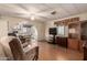 Open living space with bright lighting, ceiling fan, and laminate flooring flowing into the kitchen at 7807 E Main St # Cc105, Mesa, AZ 85207