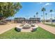 An outdoor kitchen and fire pit area with picnic tables at 7807 E Main St # Cc105, Mesa, AZ 85207