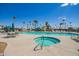Community pool and connected spa with blue railings surrounded by palm trees and desert landscaping at 7807 E Main St # Cc105, Mesa, AZ 85207
