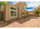 Home exterior showcasing a covered patio, mature landscaping, and private backyard at 826 W Devon Dr, Gilbert, AZ 85233