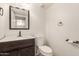 Cozy powder room with dark wood vanity, a round sink, and a modern toilet at 826 W Devon Dr, Gilbert, AZ 85233