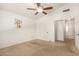 Carpeted bedroom has vaulted ceilings and closet with sliding door at 826 W Devon Dr, Gilbert, AZ 85233