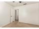 This bedroom has neutral carpeting and an open door to an adjacent room at 826 W Devon Dr, Gilbert, AZ 85233
