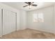 This bedroom offers natural light from its window and a ceiling fan for comfort at 826 W Devon Dr, Gilbert, AZ 85233