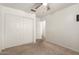 Bedroom featuring neutral carpet, double closets, soft walls, and a TV mount at 826 W Devon Dr, Gilbert, AZ 85233