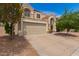 Exterior of home with desert landscaping and a two car garage at 826 W Devon Dr, Gilbert, AZ 85233
