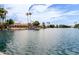 Beautiful lake view featuring waterfront homes and palm trees under a partly cloudy sky at 826 W Devon Dr, Gilbert, AZ 85233
