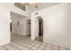 Bright living space with an open doorway to the kitchen and large tile flooring, perfect for modern living at 826 W Devon Dr, Gilbert, AZ 85233