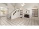 Bright living room with soaring ceilings, a cozy fireplace, and staircase, with large tile floors for a modern look at 826 W Devon Dr, Gilbert, AZ 85233