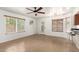 Bright and airy living space featuring tile floors, a ceiling fan, a doorway to the exterior, and direct access to the kitchen at 826 W Devon Dr, Gilbert, AZ 85233