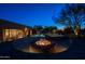 Inviting backyard oasis featuring a pool, spa, fire pit, and covered patio for luxurious outdoor living at 8392 E Eagle Feather Rd, Scottsdale, AZ 85266