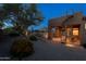 Beautifully landscaped backyard featuring a spiral staircase to upper patio and inviting sitting area at 8392 E Eagle Feather Rd, Scottsdale, AZ 85266