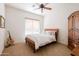 Bright bedroom featuring a queen-sized bed and a guitar at 8392 E Eagle Feather Rd, Scottsdale, AZ 85266