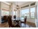 Breakfast nook features a glass top table, leather chairs and multiple windows with a view at 8392 E Eagle Feather Rd, Scottsdale, AZ 85266