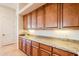 The butlers pantry has granite counters, recessed lighting, and raised panel cabinets at 8392 E Eagle Feather Rd, Scottsdale, AZ 85266