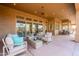 Relaxing covered patio with ample seating, ceiling fan, and sliding glass doors offering seamless indoor-outdoor living at 8392 E Eagle Feather Rd, Scottsdale, AZ 85266