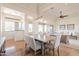 Open-concept dining room with large windows and modern chandelier flows into living area at 8392 E Eagle Feather Rd, Scottsdale, AZ 85266