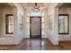 Bright foyer featuring a beautiful door, high ceilings, and travertine floors at 8392 E Eagle Feather Rd, Scottsdale, AZ 85266