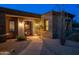 Inviting front entrance with stone accents, desert landscaping, and a paved walkway at 8392 E Eagle Feather Rd, Scottsdale, AZ 85266