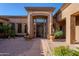 Beautifully landscaped front entrance with potted flowers, stone pavers, and a large wood door at 8392 E Eagle Feather Rd, Scottsdale, AZ 85266