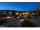 Charming home exterior with well-maintained landscaping and warm, inviting lighting at 8392 E Eagle Feather Rd, Scottsdale, AZ 85266