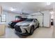 Spacious two-car garage showcasing epoxy floors, storage cabinets, and ample parking at 8392 E Eagle Feather Rd, Scottsdale, AZ 85266