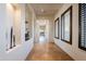 Hallway features travertine floors, custom wall niches and plantation shutters on the windows at 8392 E Eagle Feather Rd, Scottsdale, AZ 85266