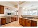 Well-equipped kitchen with stainless steel appliances, wood cabinets, stone countertops and tile flooring at 8392 E Eagle Feather Rd, Scottsdale, AZ 85266