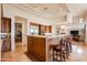 Open kitchen with stainless appliances, granite counters, and adjacent breakfast bar at 8392 E Eagle Feather Rd, Scottsdale, AZ 85266