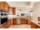 Gourmet kitchen features wood cabinetry, stone countertops, stainless steel appliances, and tile flooring at 8392 E Eagle Feather Rd, Scottsdale, AZ 85266