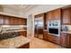 Well-equipped kitchen with wood cabinetry, stainless steel appliances, and granite countertops at 8392 E Eagle Feather Rd, Scottsdale, AZ 85266