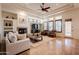 Open living room with fireplace, beamed ceiling, and neutral tones at 8392 E Eagle Feather Rd, Scottsdale, AZ 85266