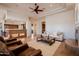 Open living room featuring fireplace, beamed ceiling, and access to kitchen at 8392 E Eagle Feather Rd, Scottsdale, AZ 85266
