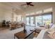 Bright living room features tan carpet, lots of windows and a view to the outdoor patio at 8392 E Eagle Feather Rd, Scottsdale, AZ 85266
